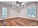 Bright, spacious bedroom featuring hardwood floors, large windows, and modern lighting at 46 Timberidge Dr, Lake Wylie, SC 29710