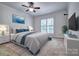 A bright bedroom with new furniture, carpet flooring, a ceiling fan, and a large window at 46 Timberidge Dr, Lake Wylie, SC 29710