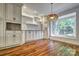 Breakfast nook featuring hardwood floors, display cabinet, window view and white cabinets at 46 Timberidge Dr, Lake Wylie, SC 29710