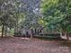 Exterior view of a home, surrounded by mature trees and lush landscaping at 46 Timberidge Dr, Lake Wylie, SC 29710