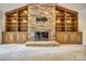 Detailed stone fireplace with built-in shelving and display cabinets at 46 Timberidge Dr, Lake Wylie, SC 29710