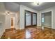 Inviting foyer with hardwood floors and elegant glass double doors at 46 Timberidge Dr, Lake Wylie, SC 29710