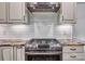 Stainless steel gas range with modern vent hood and granite countertops at 46 Timberidge Dr, Lake Wylie, SC 29710