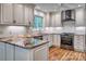 Updated kitchen with granite countertops, white cabinets, stainless appliances and hardwood flooring at 46 Timberidge Dr, Lake Wylie, SC 29710
