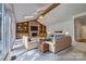 Living room featuring a stone fireplace, built-in shelving, ceiling fan and sliding glass doors and staged furniture at 46 Timberidge Dr, Lake Wylie, SC 29710