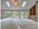 Sunlit living room with sliding doors to patio and custom built-ins at 46 Timberidge Dr, Lake Wylie, SC 29710