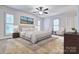 Airy main bedroom with plush carpeting, contemporary furniture, plantation shutters and a ceiling fan at 46 Timberidge Dr, Lake Wylie, SC 29710