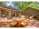 A beautifully staged patio featuring a wooden patio set with white cushions and a sliding glass door at 46 Timberidge Dr, Lake Wylie, SC 29710