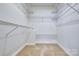 Bright walk-in closet featuring wire shelving and carpet flooring for organization at 46 Timberidge Dr, Lake Wylie, SC 29710