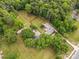 Aerial view of property showcasing a large home, green lawns, outbuildings, and privacy fencing at 4608 Beatties Ford Rd, Charlotte, NC 28216