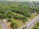 Aerial view of a property with large lawn, houses, and a surrounding neighborhood, with lots of trees at 4608 Beatties Ford Rd, Charlotte, NC 28216