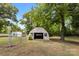 Barn featuring a half-moon roof, open entry, and fenced area at 4608 Beatties Ford Rd, Charlotte, NC 28216