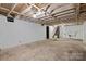 Unfinished basement with concrete floors and access to stairs, offering potential for storage or renovation at 4608 Beatties Ford Rd, Charlotte, NC 28216