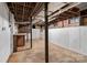 Spacious unfinished basement showcasing open ceiling, white brick walls, and concrete flooring at 4608 Beatties Ford Rd, Charlotte, NC 28216