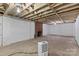 Spacious unfinished basement with exposed wood ceiling and brick fireplace, ready for customization at 4608 Beatties Ford Rd, Charlotte, NC 28216