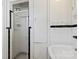 Updated bathroom with a glass-enclosed shower and integrated shelving at 4608 Beatties Ford Rd, Charlotte, NC 28216