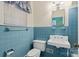 Vintage bathroom with bright blue tiling, classic fixtures, and natural light from a window at 4608 Beatties Ford Rd, Charlotte, NC 28216