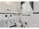 Classic bathroom featuring a pedestal sink, and black and white tiling at 4608 Beatties Ford Rd, Charlotte, NC 28216