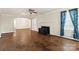 Inviting living room featuring hardwood floors and a fireplace centerpiece at 4608 Beatties Ford Rd, Charlotte, NC 28216