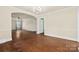 Bright and open living room with archway, hardwood floors, and chandelier at 4608 Beatties Ford Rd, Charlotte, NC 28216