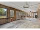 Spacious sunroom with wood paneling, multiple windows, and tile flooring at 4608 Beatties Ford Rd, Charlotte, NC 28216