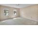 Bedroom with floral wallpaper, carpeted floors, and natural light from the two windows at 4738 Truscott Rd, Charlotte, NC 28226