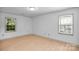 Bedroom featuring new flooring and two windows allowing natural light at 4738 Truscott Rd, Charlotte, NC 28226