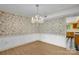 Elegant dining room with a stylish chandelier and wallpaper, perfect for entertaining guests at 4738 Truscott Rd, Charlotte, NC 28226