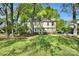 Charming two-story home with a well-maintained lawn and mature trees providing shade at 4738 Truscott Rd, Charlotte, NC 28226