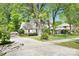 Well-maintained home showcasing a lush green lawn, mature trees, and a paved driveway at 4738 Truscott Rd, Charlotte, NC 28226