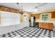 Quaint kitchen with vintage charm featuring black and white floors and stainless steel refrigerator at 4738 Truscott Rd, Charlotte, NC 28226