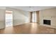 Bright living room with hardwood floors, fireplace, and french doors to the outdoors at 4738 Truscott Rd, Charlotte, NC 28226