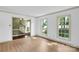 Living room featuring laminate floors and large windows allowing natural light to flood the space at 4738 Truscott Rd, Charlotte, NC 28226