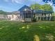 A house exterior with a screened in porch and a large green lawn and landscaping at 5013 Prestwick Ln, Charlotte, NC 28212