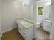 Bright bathroom featuring dual sinks and vanities, plus a window for natural light at 5013 Prestwick Ln, Charlotte, NC 28212