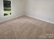 Neutral bedroom with plush carpet, a bright window and freshly painted walls at 5013 Prestwick Ln, Charlotte, NC 28212