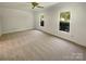Bright bedroom featuring carpet floors, white walls, a ceiling fan, and plenty of natural light at 5013 Prestwick Ln, Charlotte, NC 28212