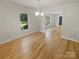 Spacious dining room featuring hardwood floors, white walls, and lots of natural light at 5013 Prestwick Ln, Charlotte, NC 28212
