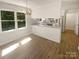Eat-in kitchen features bright white cabinets and stainless steel appliances with bar-style seating at 5013 Prestwick Ln, Charlotte, NC 28212