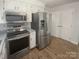 Updated kitchen boasts stainless steel appliances and ample storage for the discerning home chef at 5013 Prestwick Ln, Charlotte, NC 28212