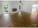 Bright and airy living room with wood floors and a large window provides ample natural light at 5013 Prestwick Ln, Charlotte, NC 28212