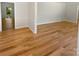 An airy living room featuring gleaming hardwood floors and crisp white trim for a modern feel at 5013 Prestwick Ln, Charlotte, NC 28212
