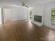 Large living room featuring brick fireplace, wood floors, and lots of natural light at 5013 Prestwick Ln, Charlotte, NC 28212