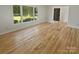 Bright living room featuring gleaming hardwood floors, natural light, and a view of the outdoors at 5013 Prestwick Ln, Charlotte, NC 28212