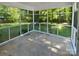 Sunroom features screened windows with lovely views and concrete flooring at 5013 Prestwick Ln, Charlotte, NC 28212