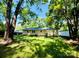 Grassy backyard featuring established shade trees and fencing at 509 North St, Belmont, NC 28012