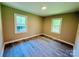 Bedroom has neutral paint, newer flooring, and large window at 509 North St, Belmont, NC 28012