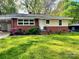 Charming brick home with a manicured lawn and a cozy carport for convenient parking at 509 North St, Belmont, NC 28012