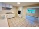 Traditional kitchen with white cabinets, sleek countertops, and tiled floors at 509 North St, Belmont, NC 28012