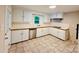 Well-lit kitchen with white cabinets, stainless steel appliances, and tile flooring at 509 North St, Belmont, NC 28012